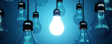 Graphic image of single lightbulb lighting up, surrounded by dark bulbs.