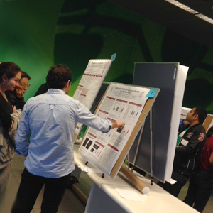 Photo of students discussing poster.