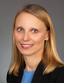Photo of a smiling caucasian woman with shoulder-length blonde hair.