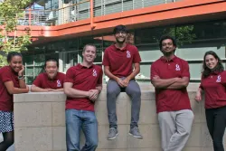 Photo of 5 Travel Award recipients standing in the Clark Center courtyard.