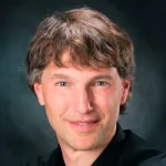 Headshot portrait of Alex Aiken - Alcatel-Lucent Professor in Communications and Networking and Professor of Computer Science
