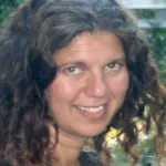 Outdoor headshot photo of smiling white female faculty member, Dr. Ayelet Voskoboynik, Assistant Professor of Biology at Stanford.