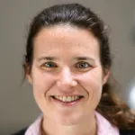 Photo of a smiling white female faculty member with long brown hair tied back in a ponytail, Dr. Barbara Engelhardt, Professor of Biomedical Data Science at Stanford University.