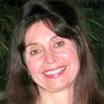 Headshot portrait of Michele Calos - Professor of Genetics