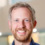 Headshot portrait of a smiling white male faculty member, Dr. Cory Shain, Assistant Professor of Linguistics at Stanford University.