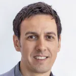 Photo of smiling white male faculty member, Dr. Eric Pop, Professor of Electrical Engineering at Stanford University.
