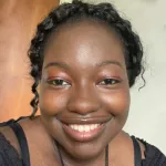 Photo of smiling female undergraduate student Bene Farrell.