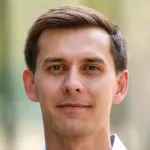 Outdoor headshot photo of a smiling white male faculty member, Dr. Felix Horns, Assistant Professor of Genetics at Stanford University.