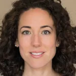 Photo of smiling white female faculty member with long curly brown hair, Dr. Fiona Baumer, Assistant Professor of Neurology and Pediatrics at Stanford University.