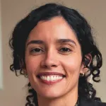 Indoor headshot photo of a smiling female faculty member, Dr. Gabriella Harari, Assistant Professor of Communication at Stanford University.