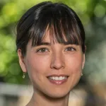 Outdoor headshot photo of a smiling female faculty member, Dr. Gabrielle Wong-Parodi, Assistant Professor of Earth System Science at Stanford University.