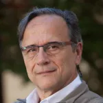 Headshot portrait of Leonidas Guibas - Paul Pigott Professor in the School of Engineering and Professor of Computer Science and (by courtesy) of Electrical Engineering