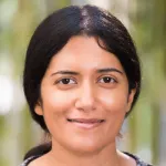 Outdoor headshot photo of a smiling Southeast Asian female faculty member, Dr. Hemamala Karunadasa, Associate Professor of Chemistry at Stanford University.