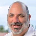 Outdoor headshot photo of a smiling male faculty member, Dr. James Landay, the Anand Rajaraman and Venky Harinarayan Professor of Computer Science at Stanford University.