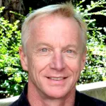 Outdoor headshot photo of a smiling white male faculty member, Dr. James Lock, the Eric Rothenberg MD Professor of Psychiatry & Behavioral Sciences at Stanford University.