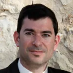 Outdoor headshot photo of a smiling white male faculty member, Dr. Justin Annes, Associate Professor of Medicine at Stanford University.