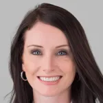 Photo of smiling white female faculty member with long straight brown hair, Dr. Kelly Mahaney, Assistant Professor of Neurosurgery at Stanford University.