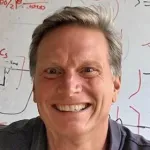 Indoor headshot photo of a smiling white male faculty member, Dr. Mark Kasevich, Professor of Physics and Applied Physics at Stanford University.