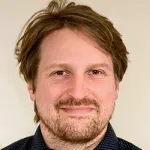 Photo of smiling white male faculty member with brown hair and a brown beard, Dr. Matthias Garten, Assistant Professor of Microbiology & Immunology and Bioengineering at Stanford.