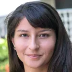Photo of smiling female faculty member, Dr. Naima Sharaf, Assistant Professor of Biology at Stanford University.