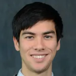 Indoor headshot photo of a smiling male faculty member, Dr. Nathan Lo, Assistant Professor of Medicine at Stanford University.
