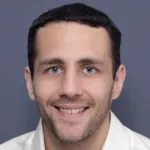 Photo of smiling white male faculty member with short dark hair, Dr. Pascal Geldsetzer, Assistant Professor of Medicine at Stanford University.