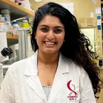 Indoor photo of a Southeast Asian female graduate student in a wet lab.