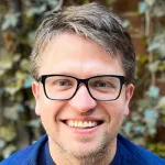 Photo of smiling white male faculty member wearing glasses, Dr. Kacper Rogala, Assistant Professor of Structural Biology and Chemical & Systems Biology at Stanford University.