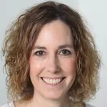 Indoor headshot photo of a smiling white female faculty member, Dr. Shirit Einav, Professor of Medicine and Microbiology & Immunology at Stanford University.