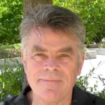 Outdoor headshot photo of a smiling white male faculty, Dr. Stephen Smith, Professor Emeritus of Molecular & Cellular Physiology at Stanford University.