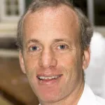 Indoor headshot photo of a smiling white male faculty member, Dr. Stephen Skirboll, Associate Professor of Neurosurgery at Stanford University.