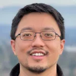 Phot of a smiling male Asian faculty member wearing glasses, Dr. Lei Stanley Qi, Associate Professor of Bioengineering at Stanford University.