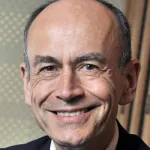 Indoor headshot photo of a smiling white male faculty member, Dr. Tom Sudhof, Professor of Molecular & Cellular Physiology at Stanford University.