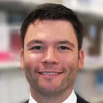 Indoor headshot photo of a smiling white male faculty member, Dr. Tobias Lanz, Assistant Professor of Medicine at Stanford University.