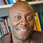 Photo of a smiling Black male faculty member, Dr. Todd Coleman, Associate Professor of Bioengineering at Stanford University.