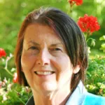 Outdoor headshot photo of a smiling white female faculty member, Dr. Virginia Walbot, Professor Emerita of Biology.