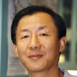 Indoor headshot photo of an Asian male faculty member, Dr. Zijie Sun, Professor Emeritus of Urology at Stanford University.