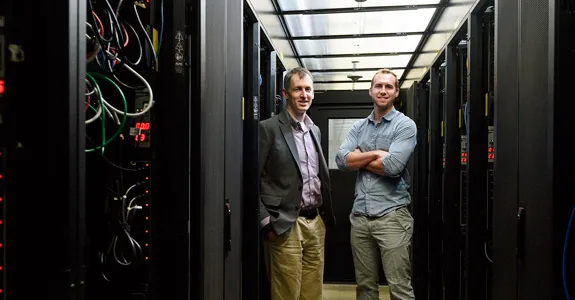 Photo of Evan Reed and Austin Sendek in server room.