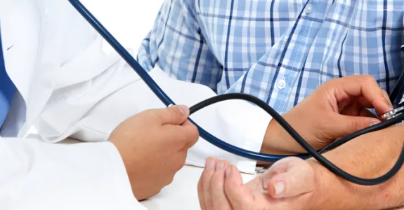 Photo of man getting his blood pressure taken.