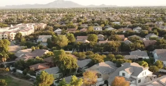 Overhead view of numerous "cookie-cutter" style houses' roofs.