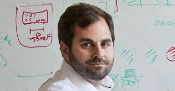 Photo of Dr. Michael Frank in front of a whiteboard.