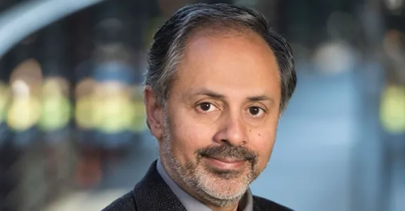 Photo of Dr. Sam Gambhir standing in middle of Clark Center building.