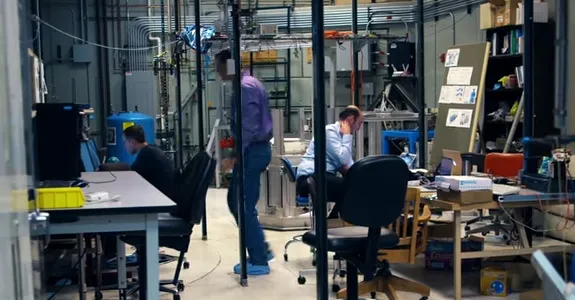 Photo of scientists working on gravitational wave research in laboratory.