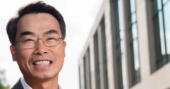 Photo of Dr. Joseph Wu in front of a building with many windows.