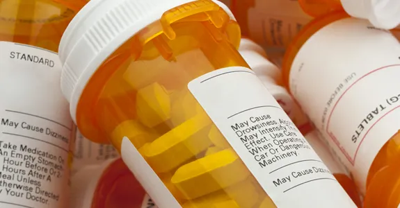 Pile of orange medication bottles.