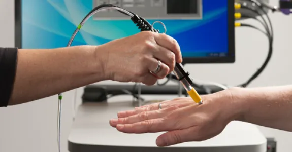 Photo by L.A. Cicero: A pen-size microscope being developed would focus a low-power laser light on a blood vessel just below the patient's skin to register dyed cancer cells.