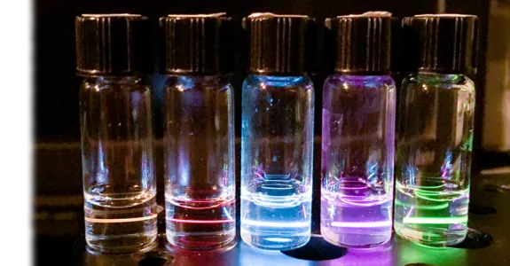 Photo of tubes emitting different colors of light.
