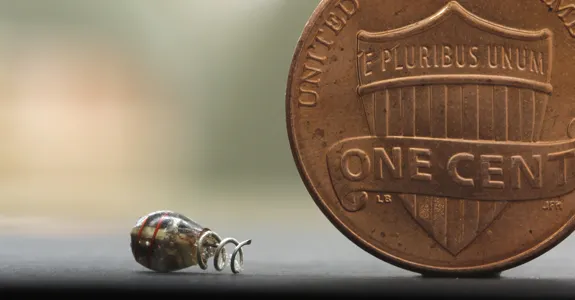 Photo of Dr. Poon's electronic device next to a penny.