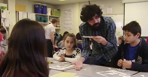 Screenshot from video of Dr. Manu Prakash showing students how to use the Foldscope.