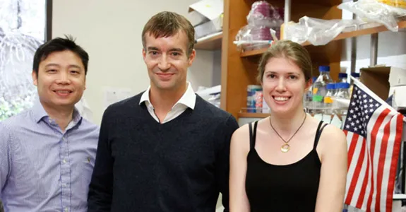 Photo of Dong Wang, Gregory Scherrer, and Elizabeth Sypek in the laboratory.